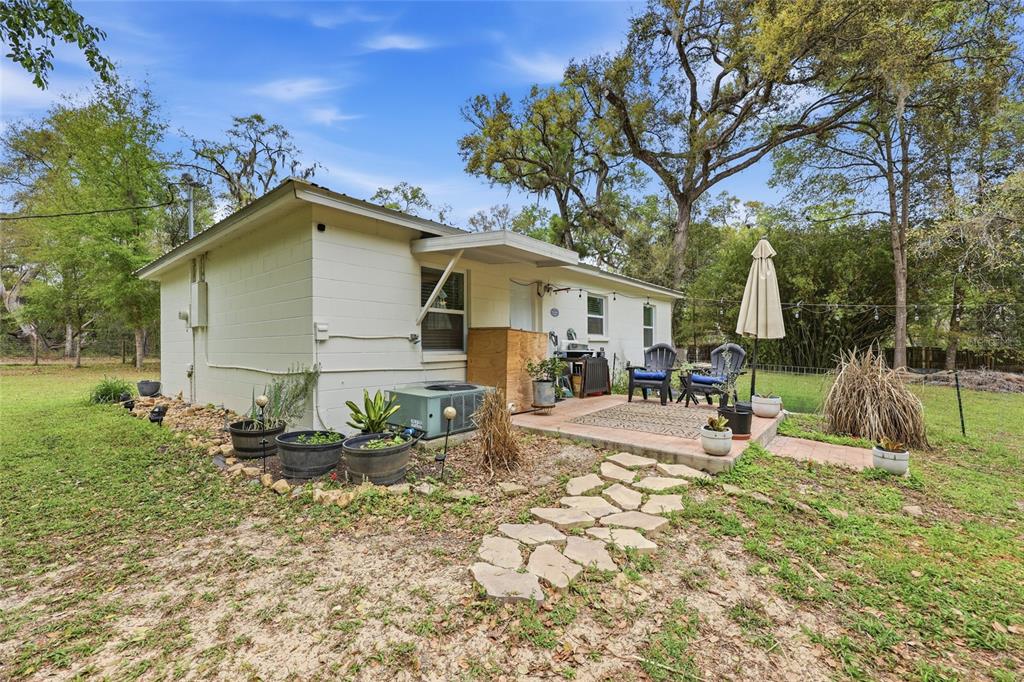 14285 Southwest 174th Street Archer, FL 32618 - Photo 16 of 25 a view of a house with backyard and sitting area