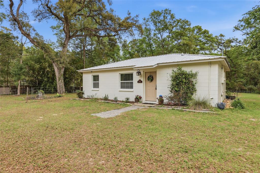 14285 Southwest 174th Street Archer, FL 32618 - Photo 2 of 25 a view of a house with a yard and garage