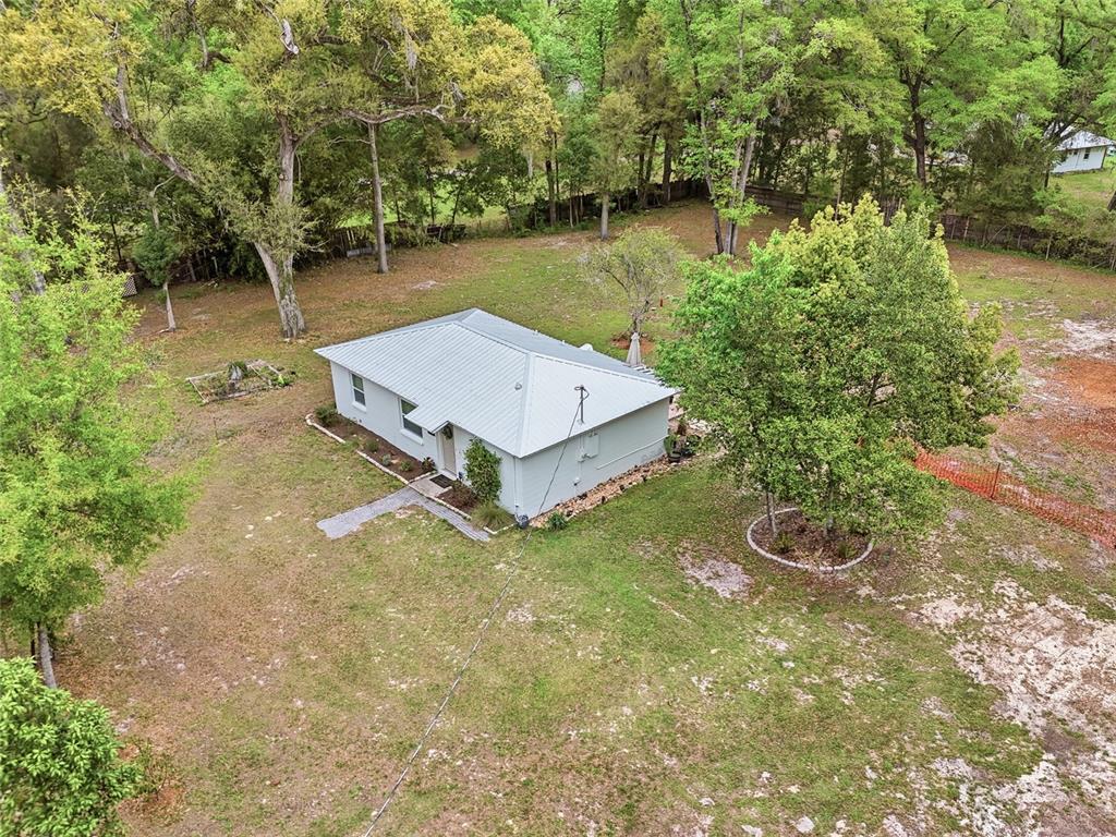 14285 Southwest 174th Street Archer, FL 32618 - Photo 23 of 25 a view of a house with pool and a yard