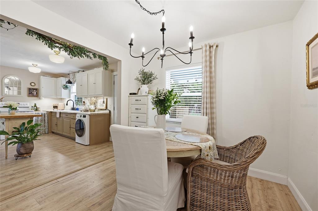14285 Southwest 174th Street Archer, FL 32618 - Photo 6 of 25 a living room with kitchen island furniture and a chandelier