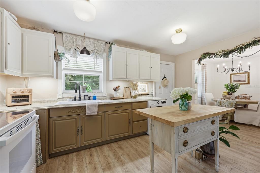 14285 Southwest 174th Street Archer, FL 32618 - Photo 8 of 25 a kitchen with a sink cabinets and wooden floor