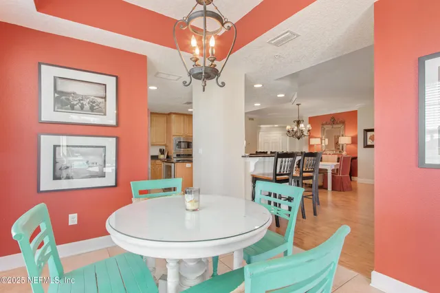 a living room with dining table and wooden floor