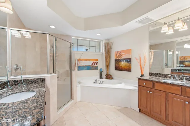 a bathroom with a granite countertop sink mirror and bathtub