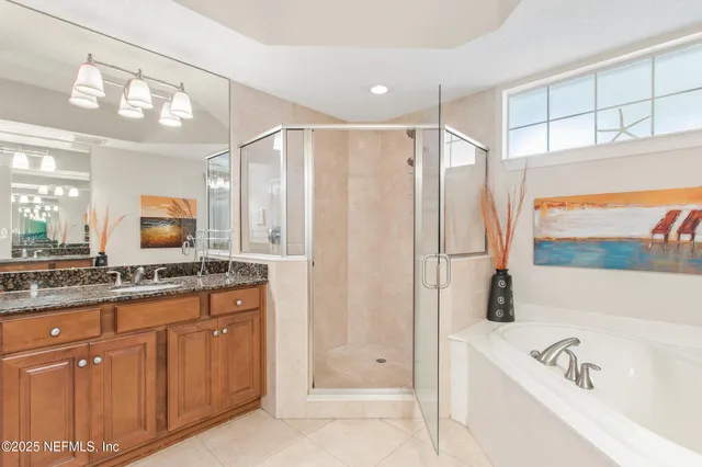 a bathroom with a tub a sink and mirrors