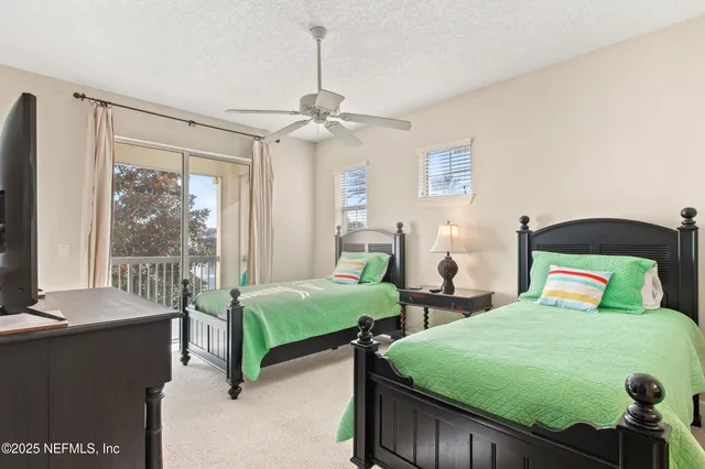 a bedroom with two beds and a chandelier