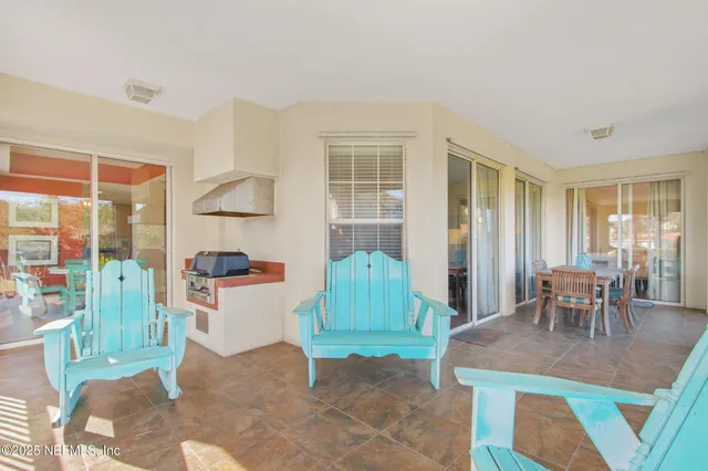 a living room with furniture a window and a dining table