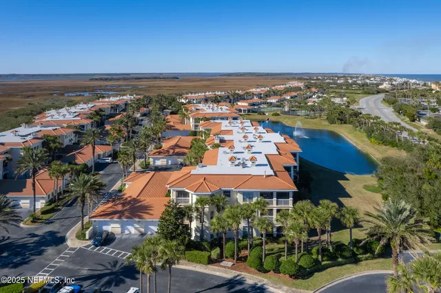 an aerial view of residential building and ocean