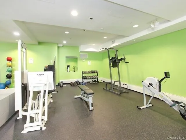 a room with gym equipment and mirrors