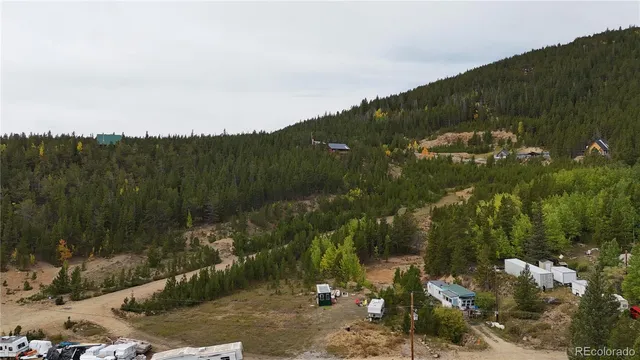 a view of a lush green hillside and houses