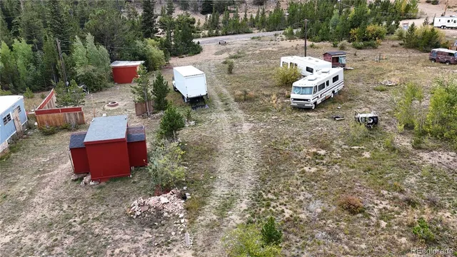 a view of a backyard with table and chairs