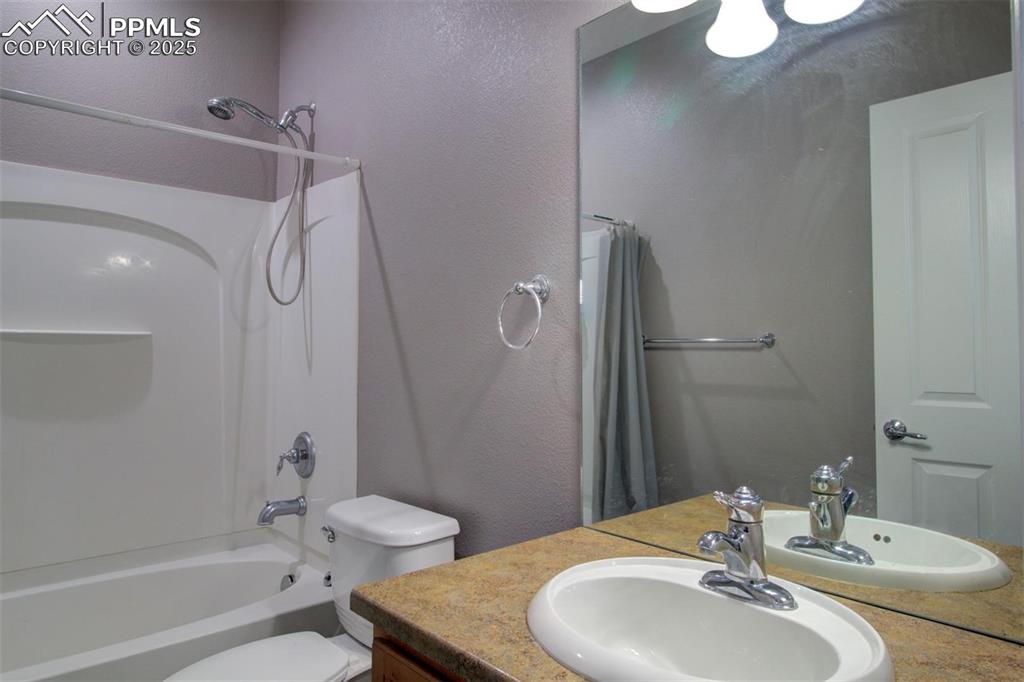 7627 Loopout Grove Peyton, CO 80831 - Photo 18 of 21 a bathroom with a sink toilet and shower