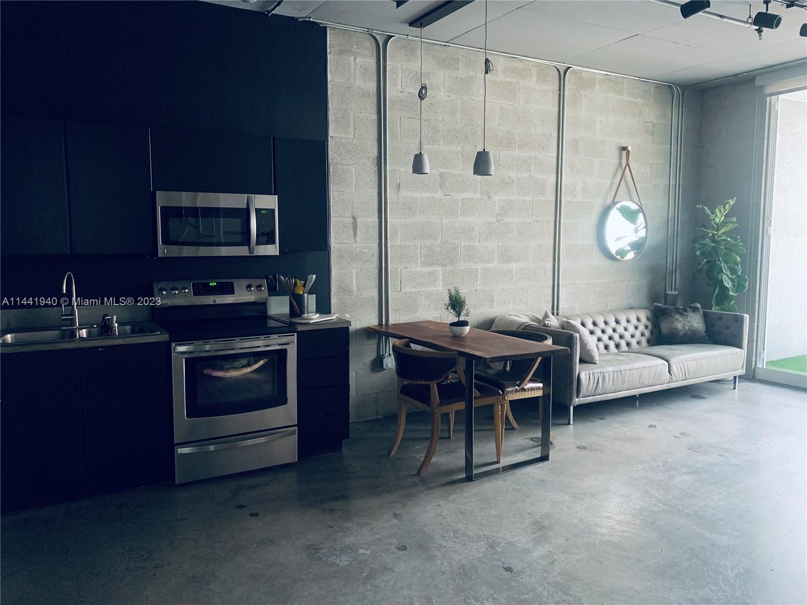 Edgewater Miami, FL 33137 - Photo 6 of 14 a kitchen with a table chairs and a stove