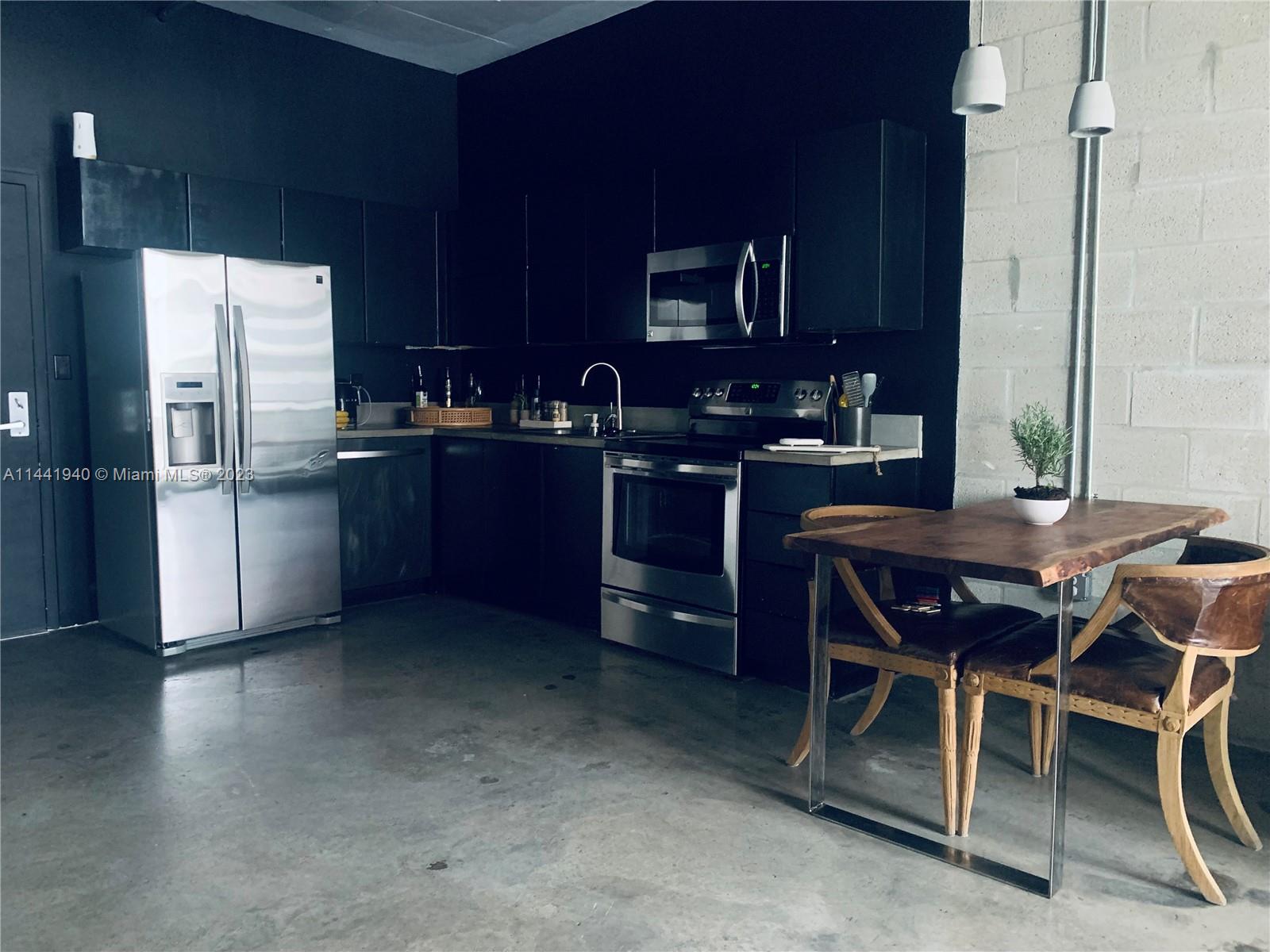 Edgewater Miami, FL 33137 - Photo 7 of 14 a kitchen with stainless steel appliances granite countertop a sink stove and refrigerator