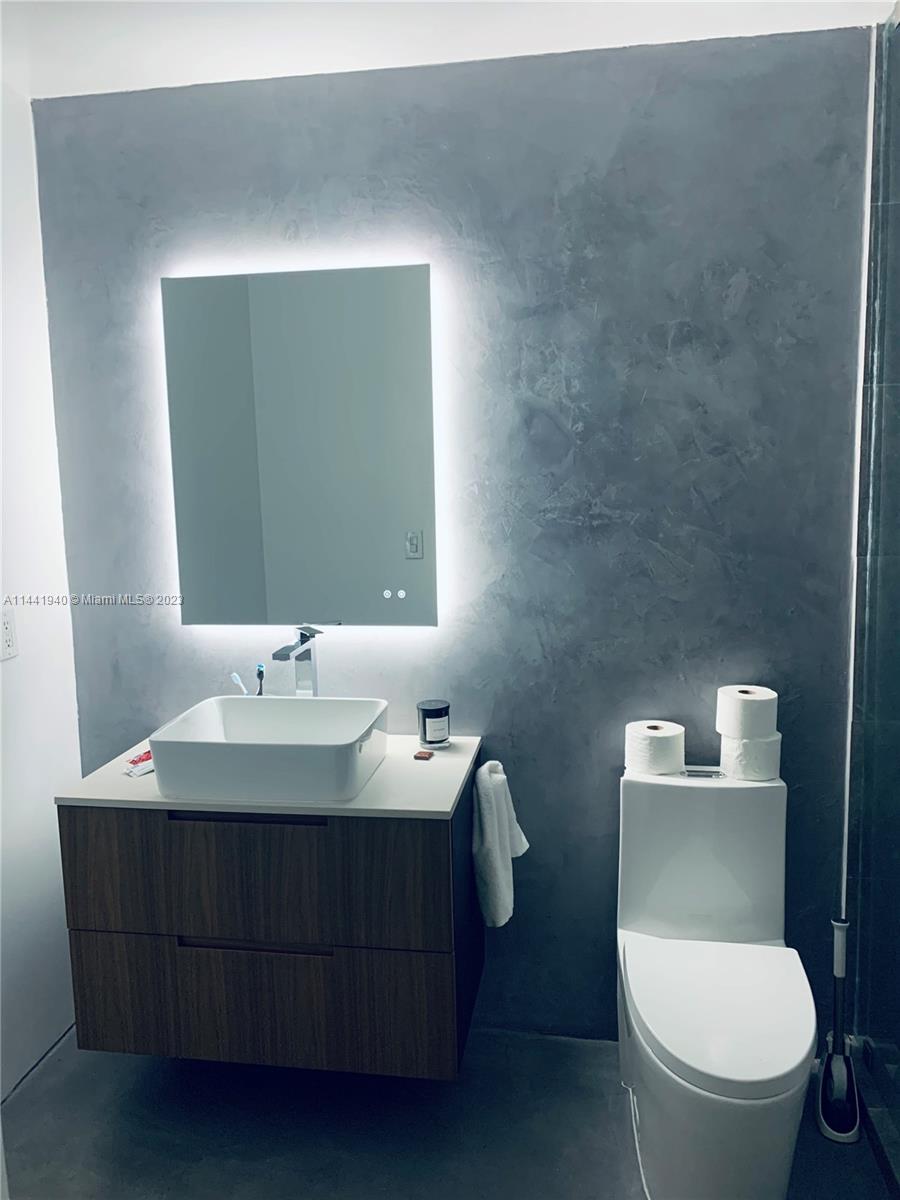 Edgewater Miami, FL 33137 - Photo 8 of 14 a bathroom with a toilet sink and mirror