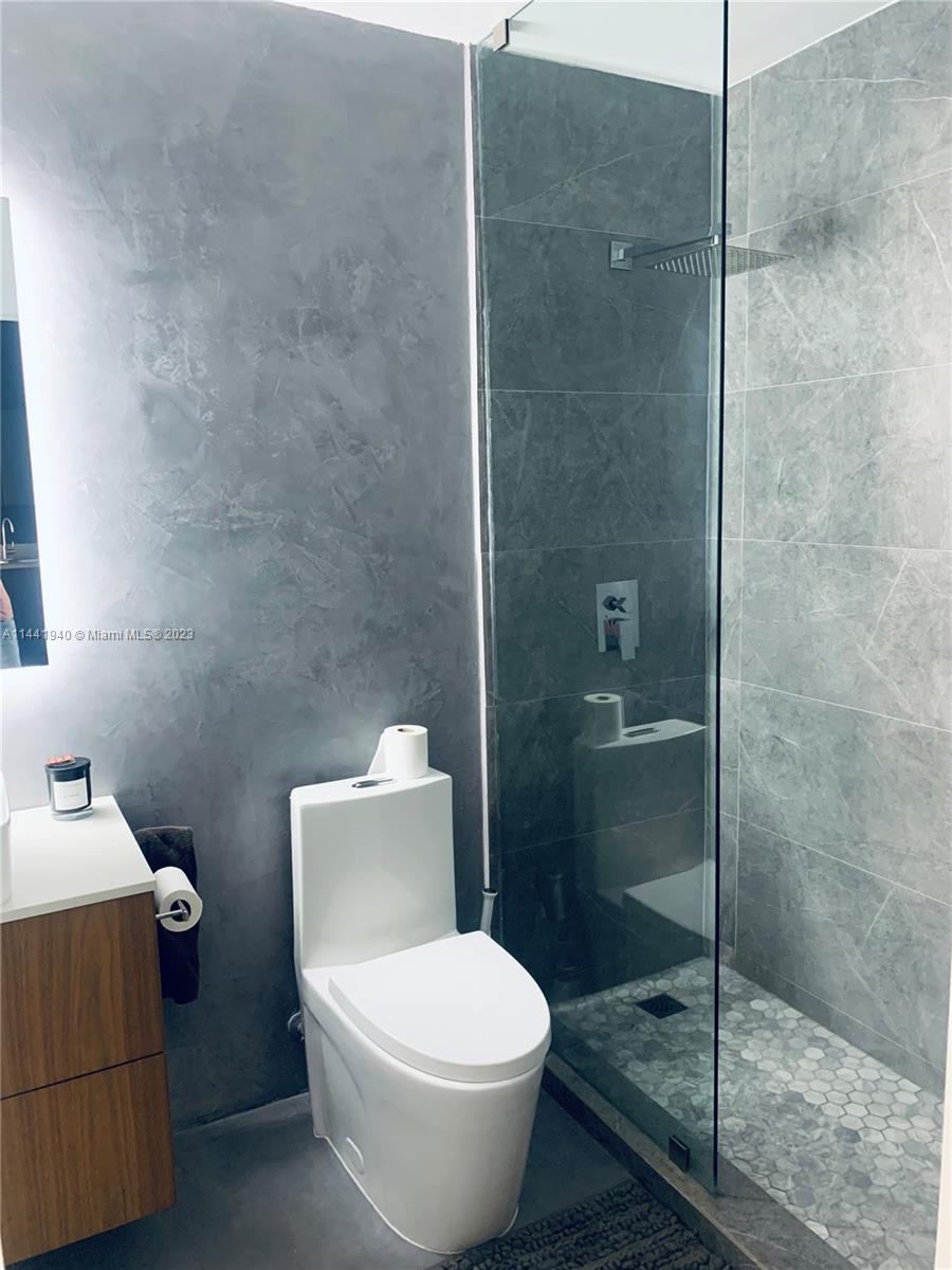 Edgewater Miami, FL 33137 - Photo 9 of 14 a white toilet sitting next to a bathroom sink