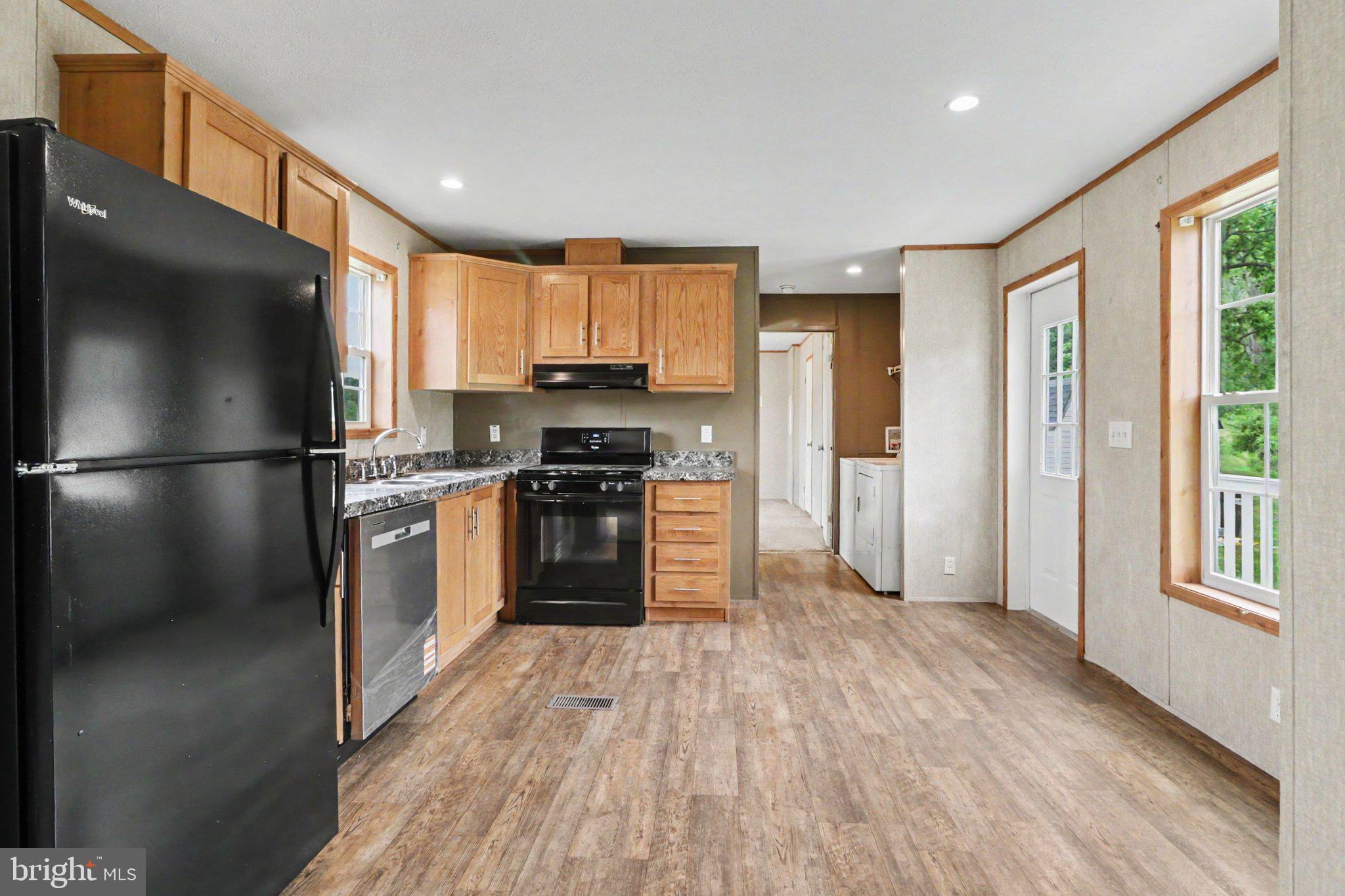 66 Kip Road Halifax, PA 17032 - Photo 5 of 16 a kitchen with stainless steel appliances granite countertop a refrigerator a stove and a wooden floors