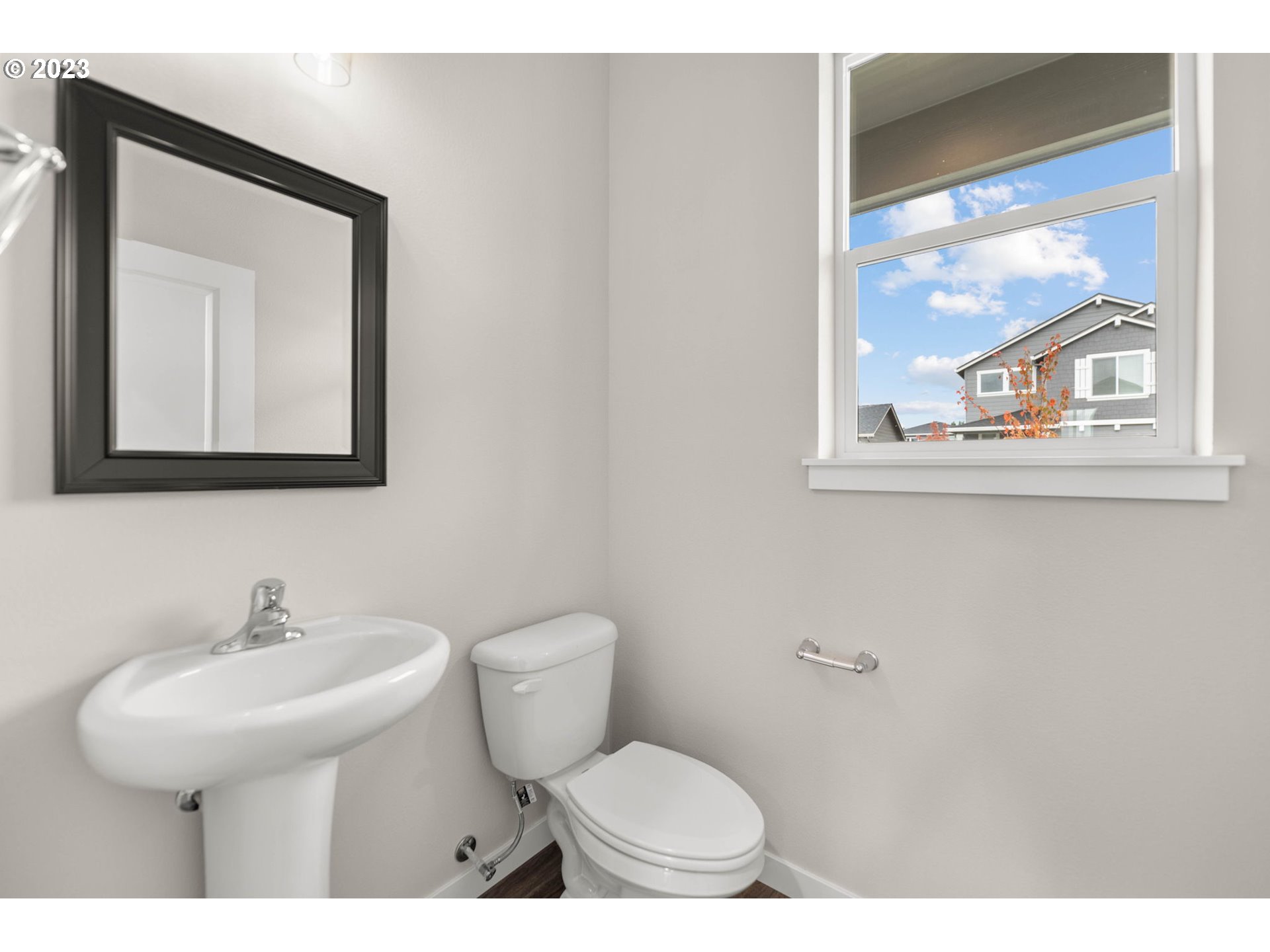 8847 North 3rd Circle Ridgefield, WA 98642 - Photo 5 of 40 a bathroom with a toilet a sink and a mirror