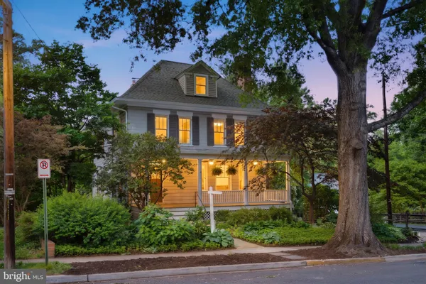 a front view of a house with a tree