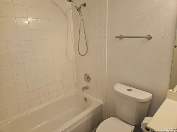 a bathroom with a sink vanity and toilet