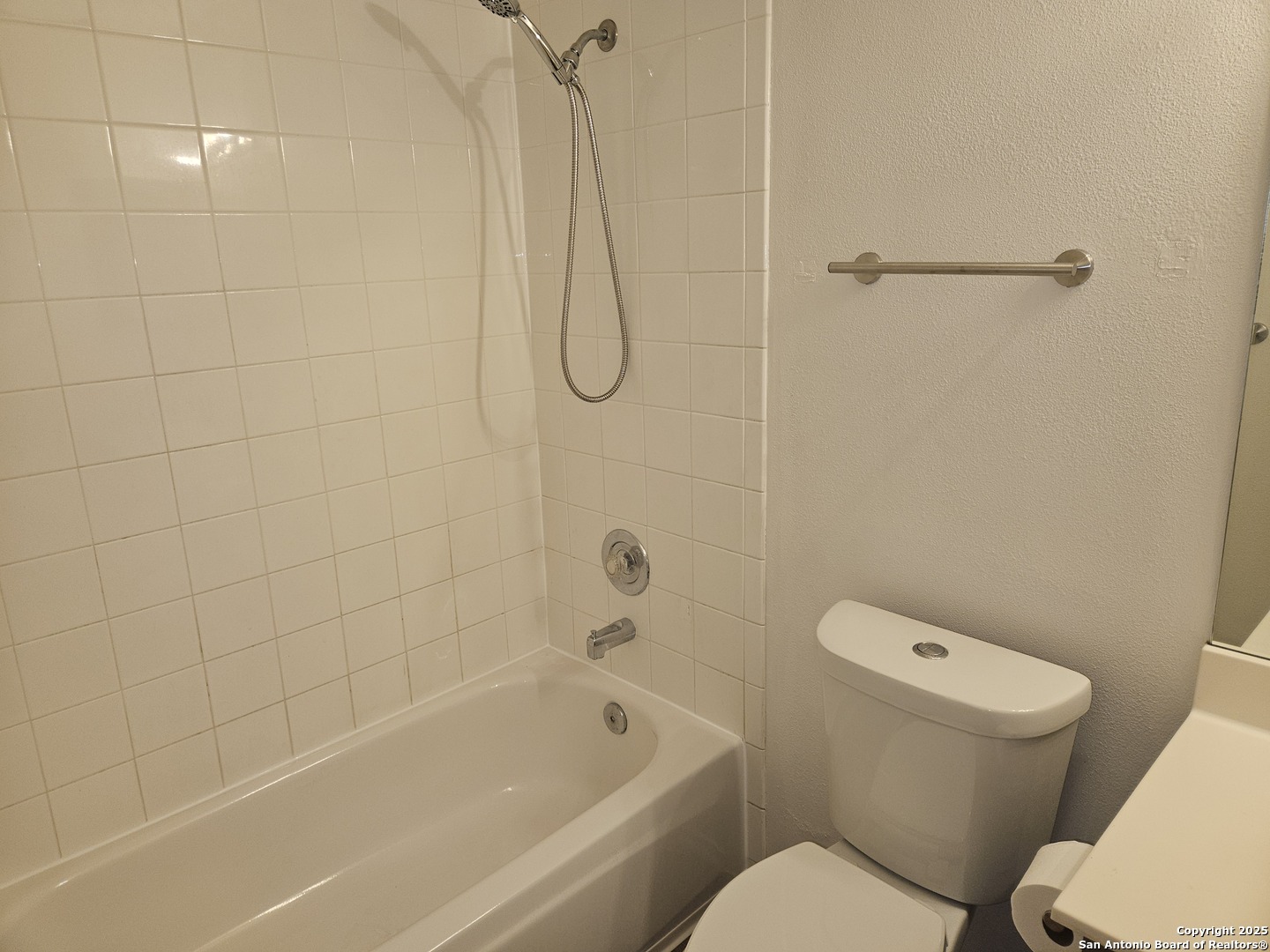 7715 Rustic Lane San Antonio, TX 78230 - Photo 18 of 26 a bathroom with a toilet and a shower