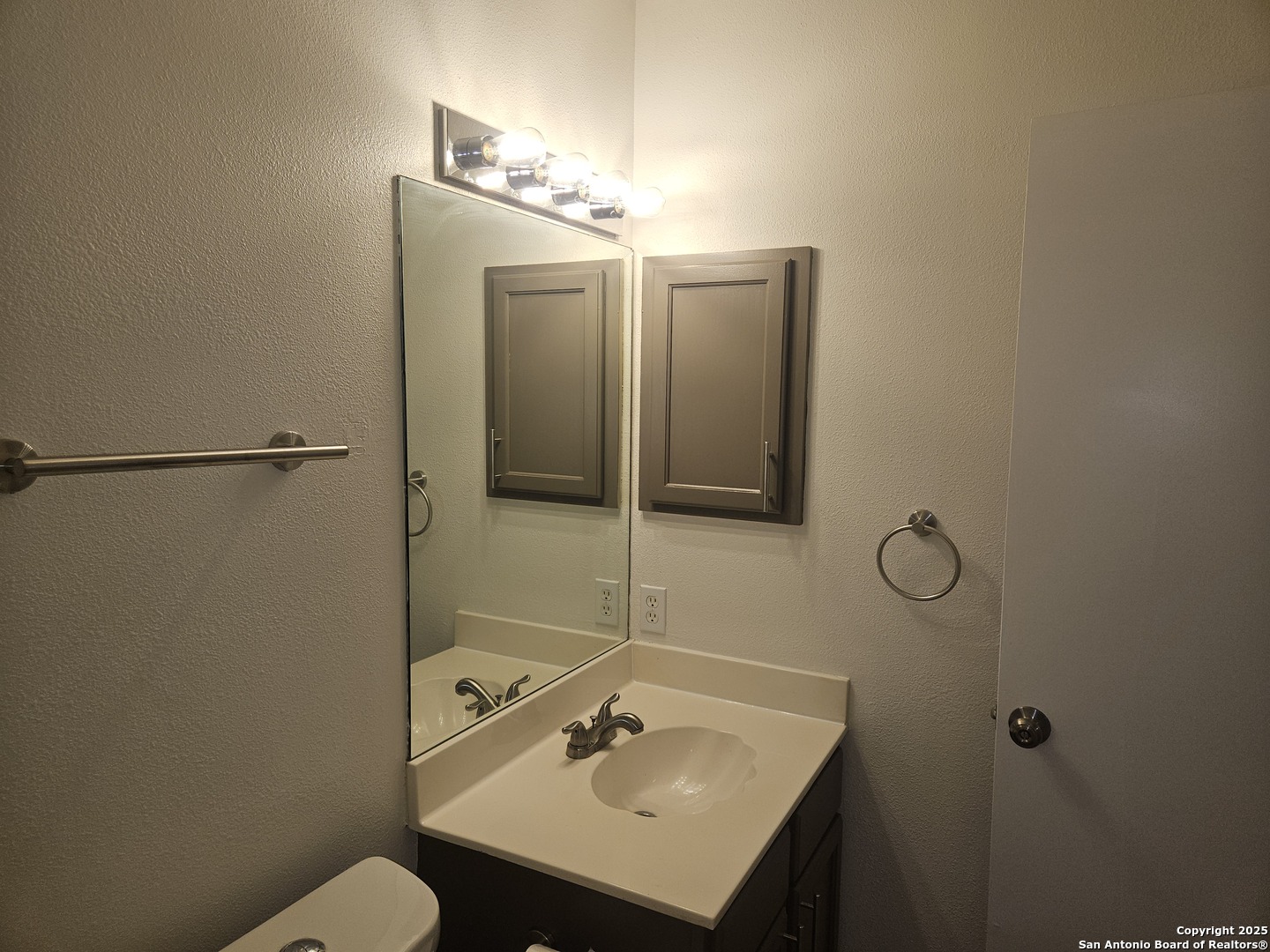 7715 Rustic Lane San Antonio, TX 78230 - Photo 19 of 26 a bathroom with a sink vanity and toilet