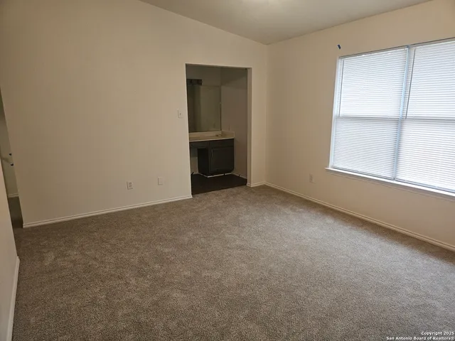a view of an empty room with a fireplace