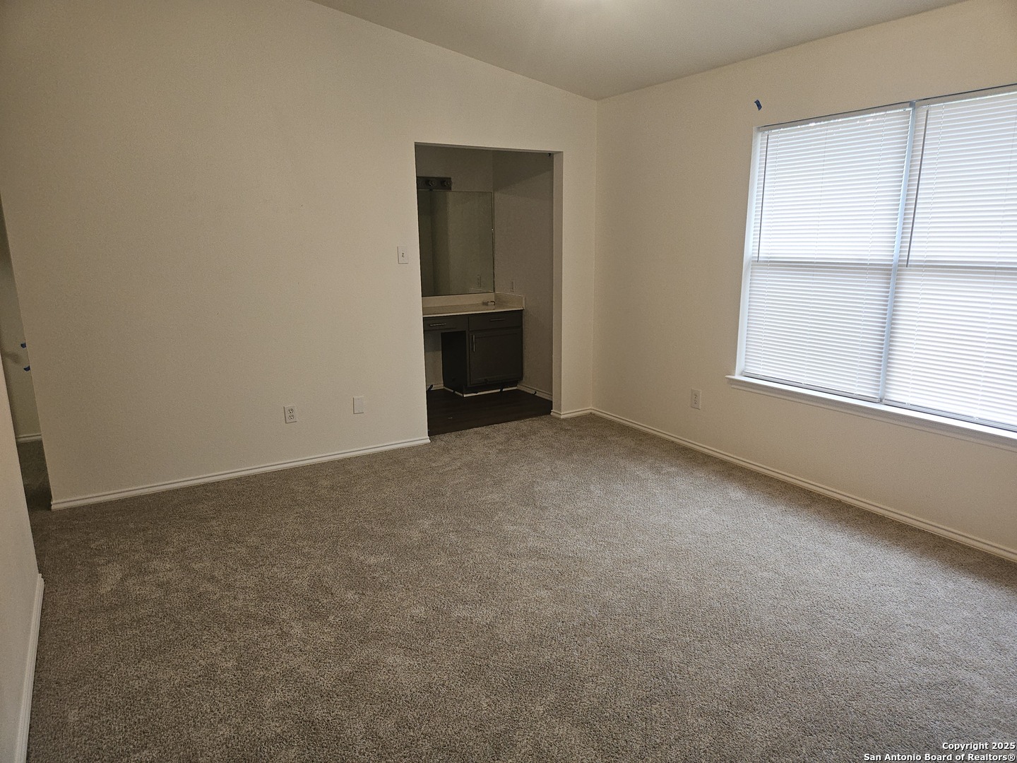 7715 Rustic Lane San Antonio, TX 78230 - Photo 20 of 26 an empty room with a fireplace and windows