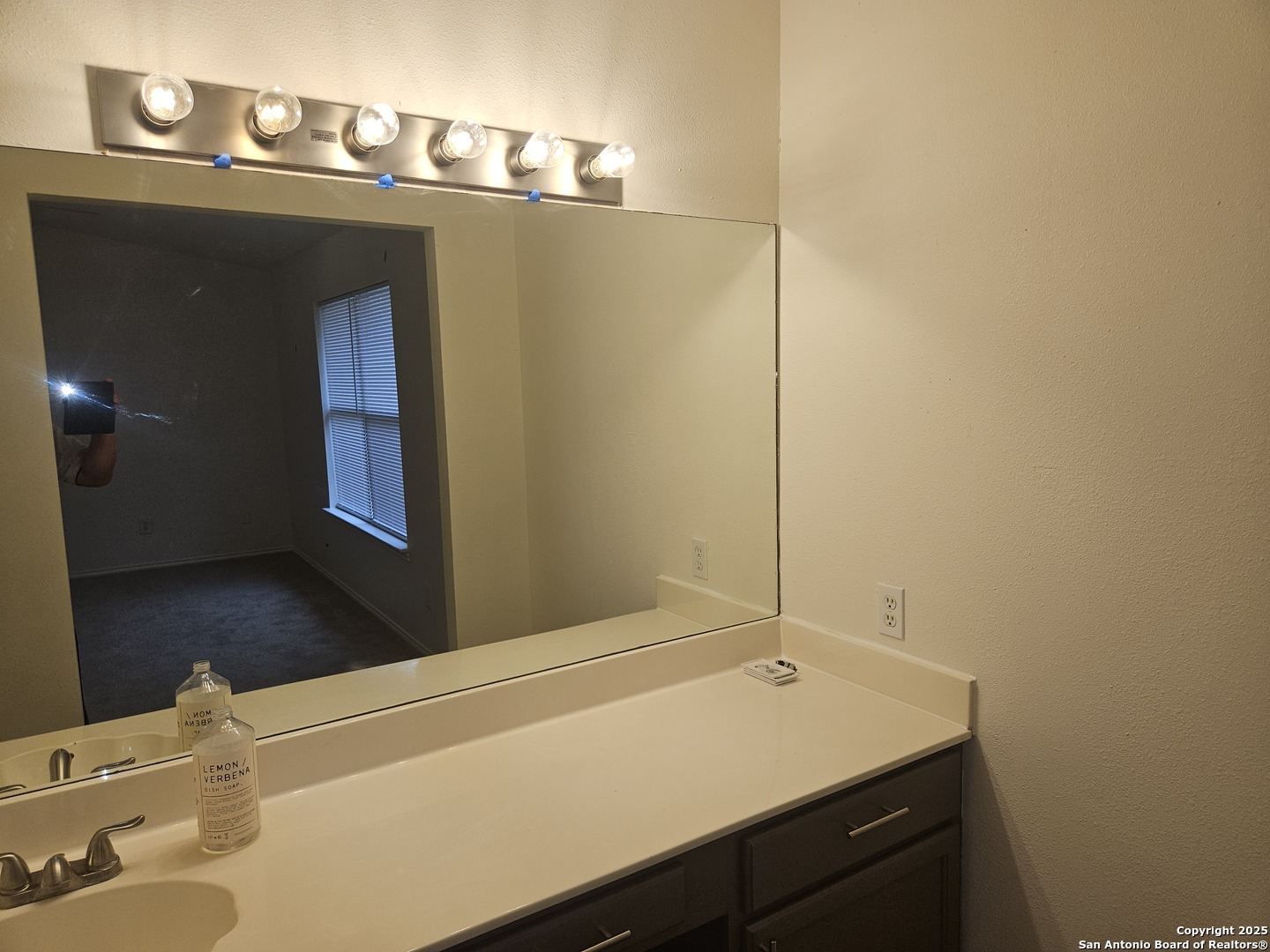7715 Rustic Lane San Antonio, TX 78230 - Photo 22 of 26 a bathroom with a sink and a mirror