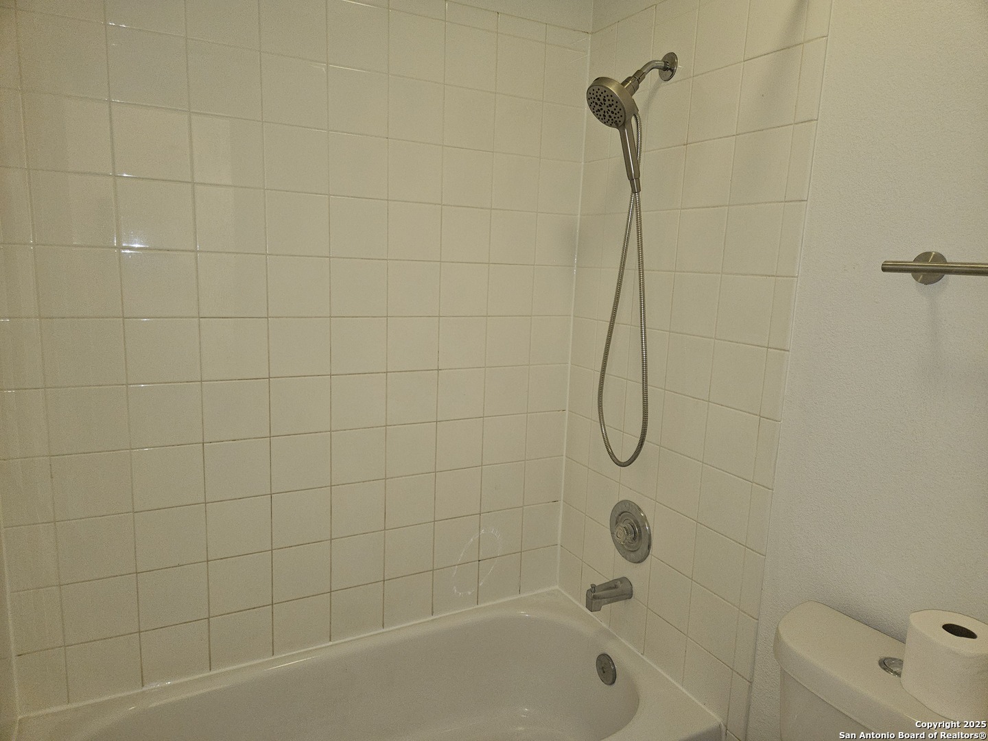 7715 Rustic Lane San Antonio, TX 78230 - Photo 23 of 26 a bathroom with a bath tub with a shower