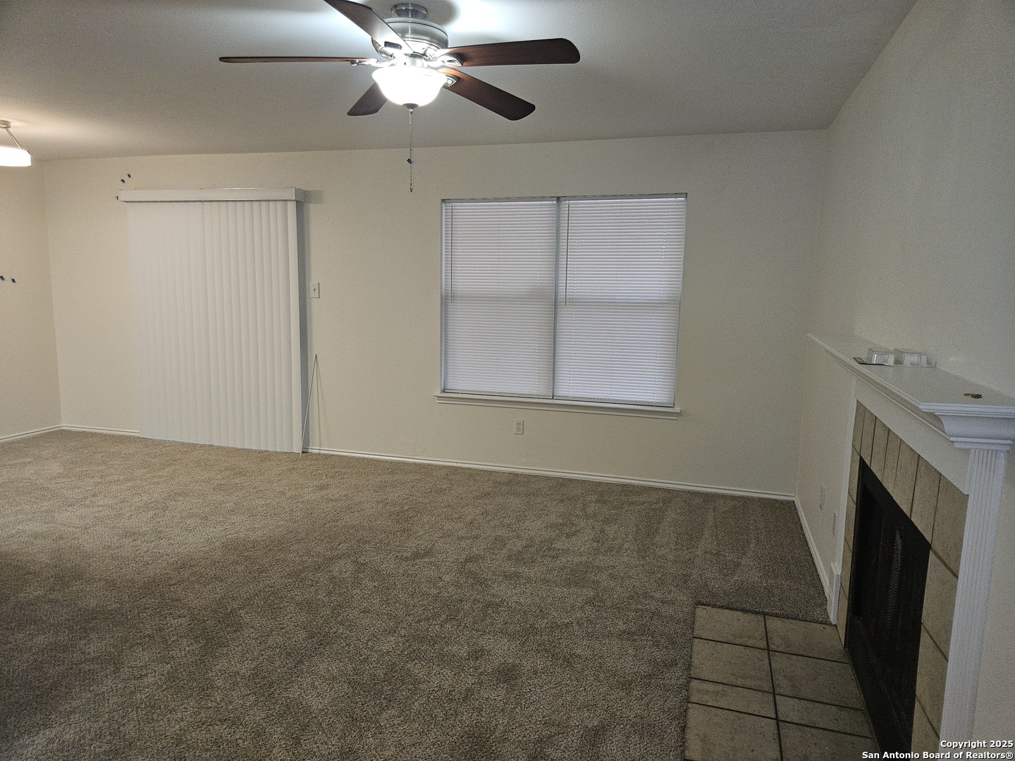 7715 Rustic Lane San Antonio, TX 78230 - Photo 4 of 26 a view of an empty room with a fireplace and a window