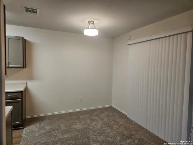 a view of an empty room with a mirror