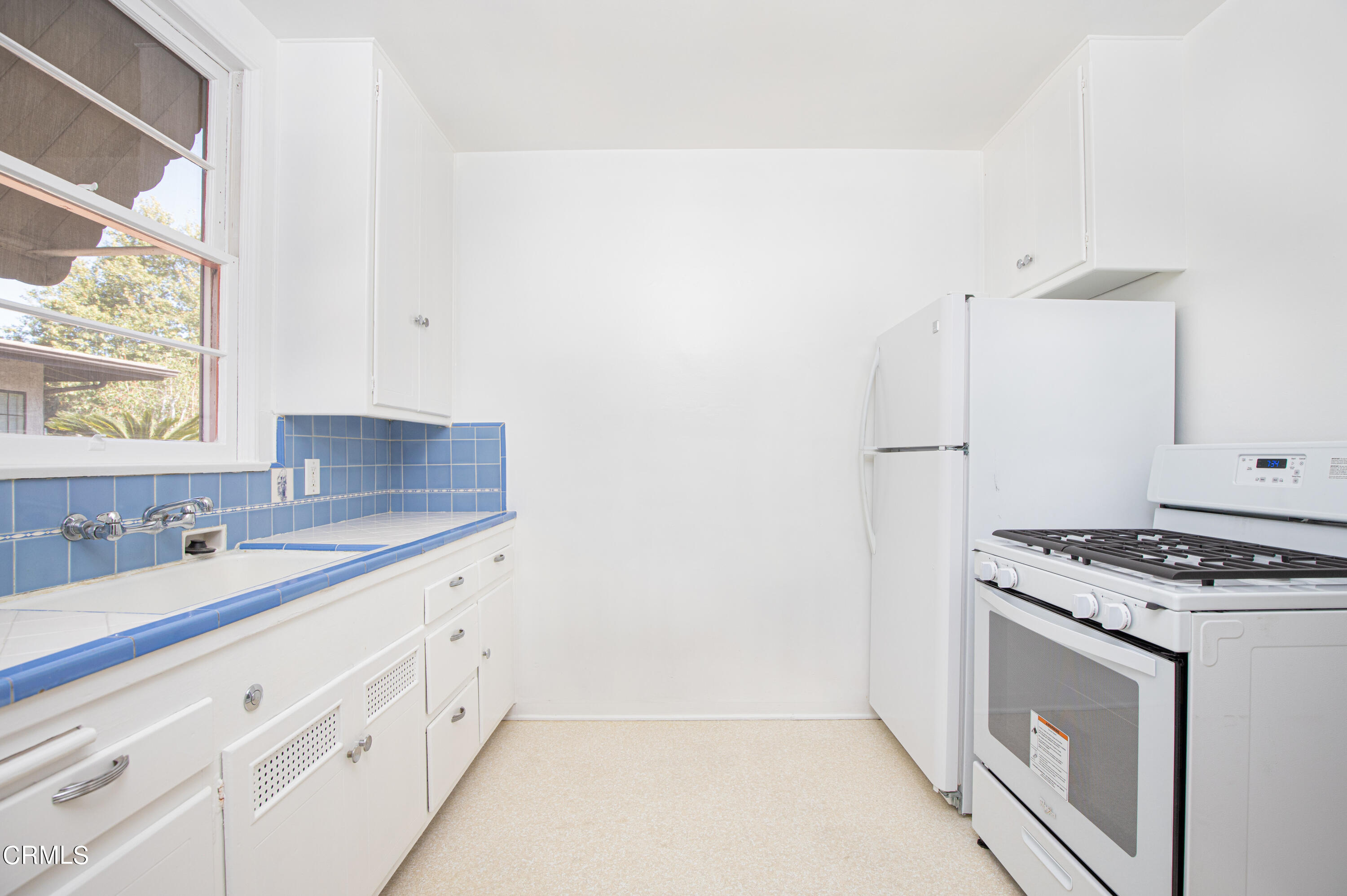 1562 Riverside Drive Glendale, CA 91201 - Photo 4 of 12 a kitchen with granite countertop a sink a stove and cabinets