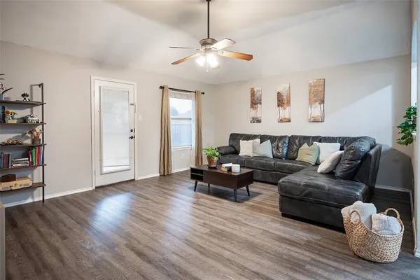 a living room with furniture and wooden floor