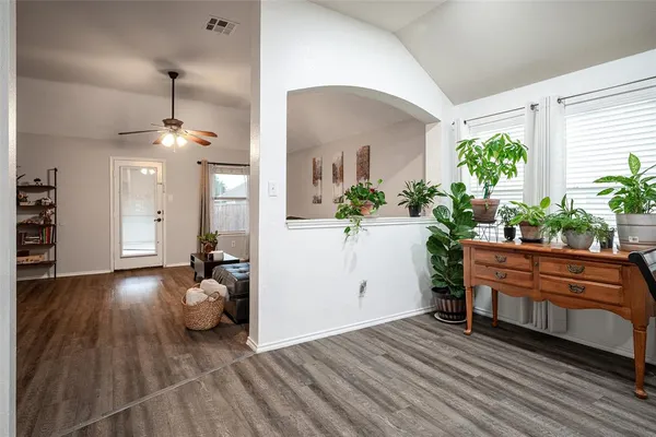 a living room with furniture and a potted plant