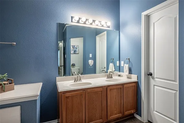 a bathroom with a double vanity sink and a mirror