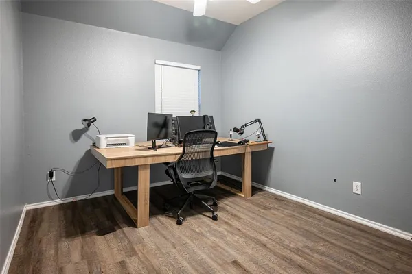 a view of a workspace with wooden floor