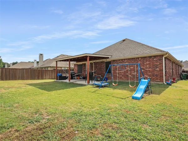 a view of a house with swimming pool and a yard