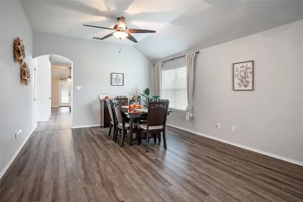 a view of a dining room with furniture and wooden floor