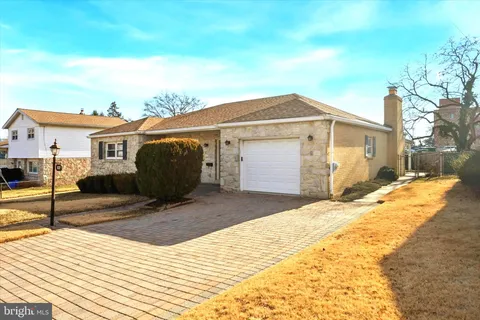 a view of a house with wooden fence