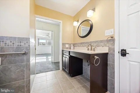 a bathroom with a sink a vanity and a mirror