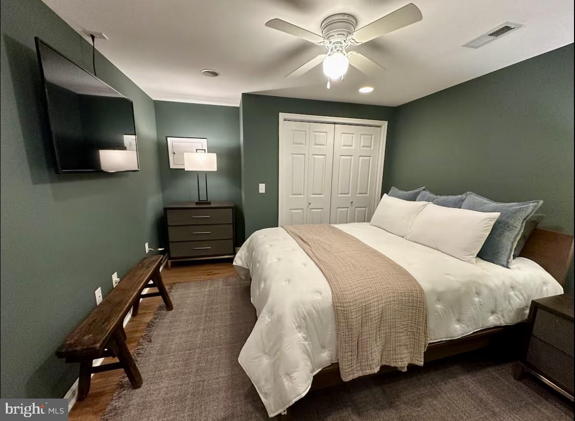 411 Whiskey Still Road Linden, VA 22642 - Photo 13 of 31 a bedroom with a bed and a flat tv screen on dresser