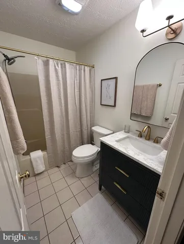 a bathroom with a sink mirror vanity and toilet