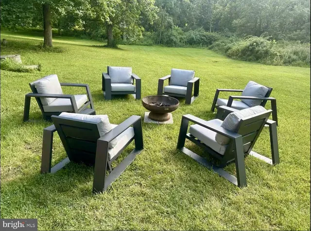 a view of a patio with lawn chairs