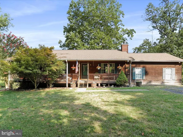 a view of a house with a yard and sitting area