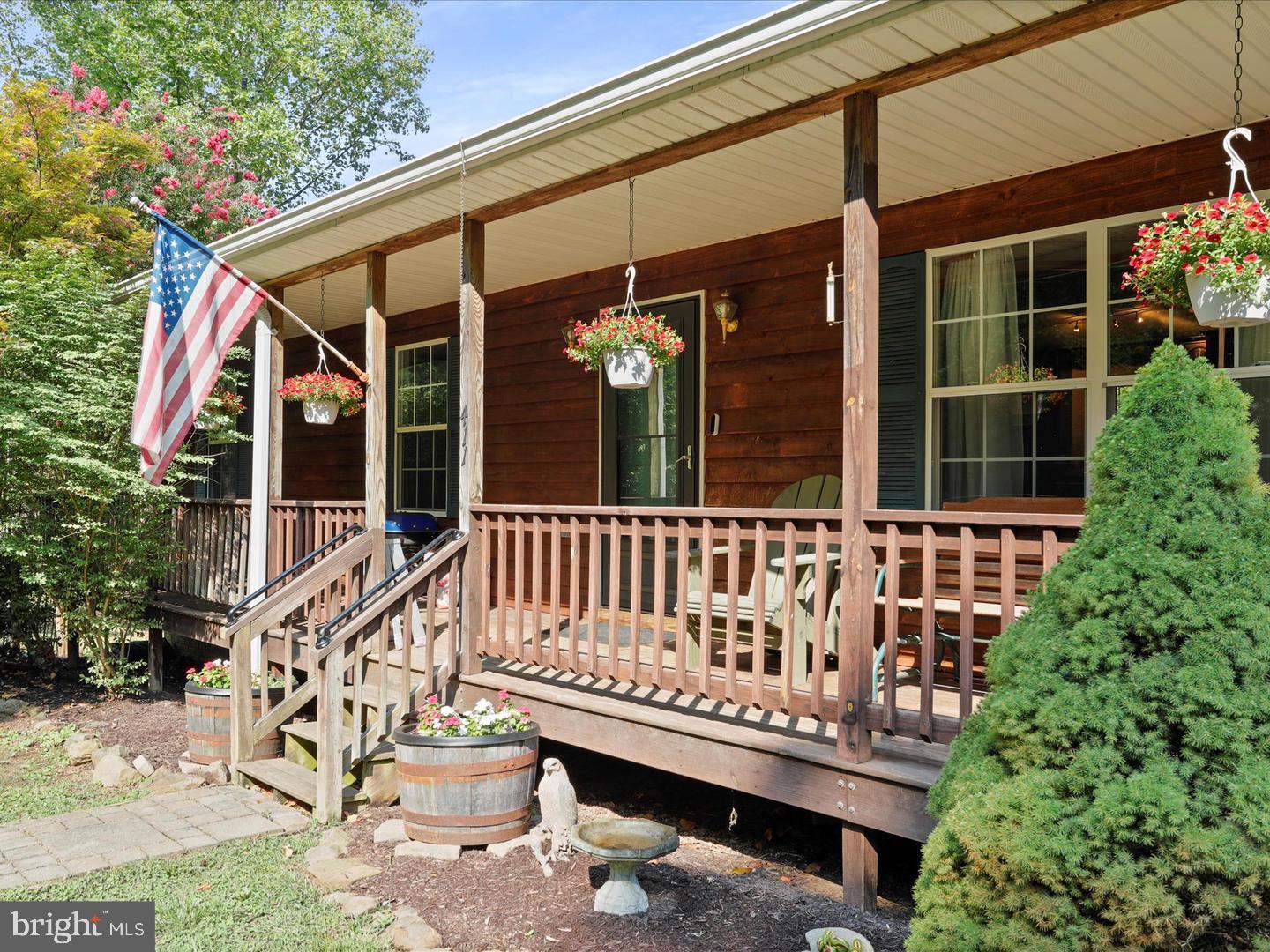 411 Whiskey Still Road Linden, VA 22642 - Photo 27 of 31 a view of a house with a wooden deck and a bench