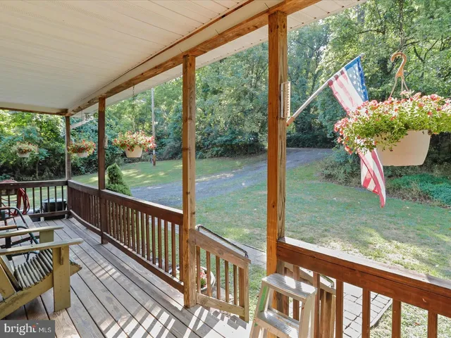 a view of a porch with furniture and garden