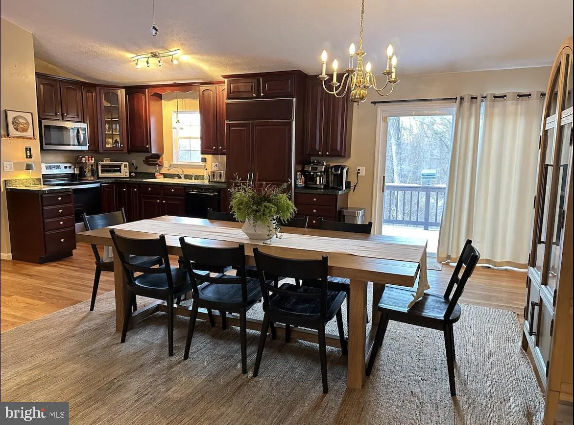 411 Whiskey Still Road Linden, VA 22642 - Photo 3 of 31 a view of a dining room with furniture window and wooden floor