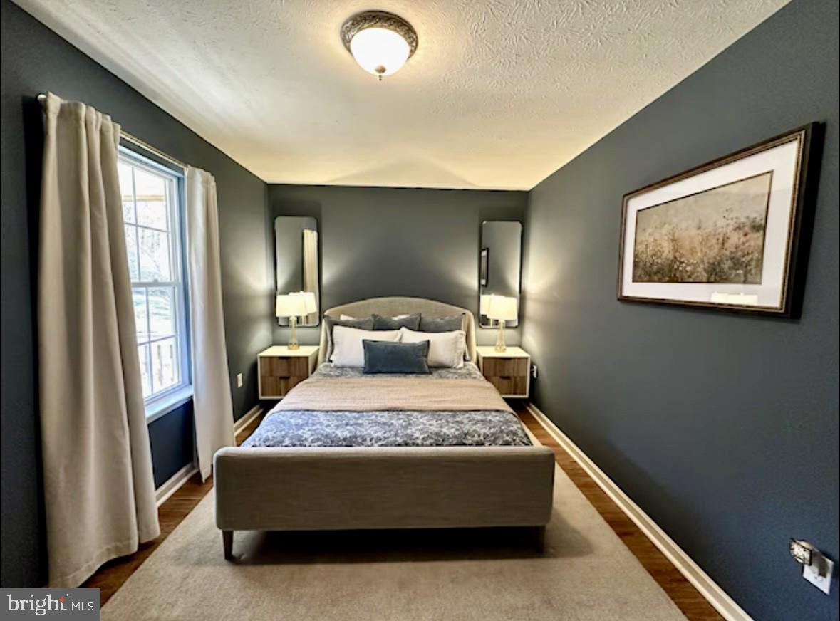 411 Whiskey Still Road Linden, VA 22642 - Photo 6 of 31 a bed sitting in a spacious bedroom next to a window