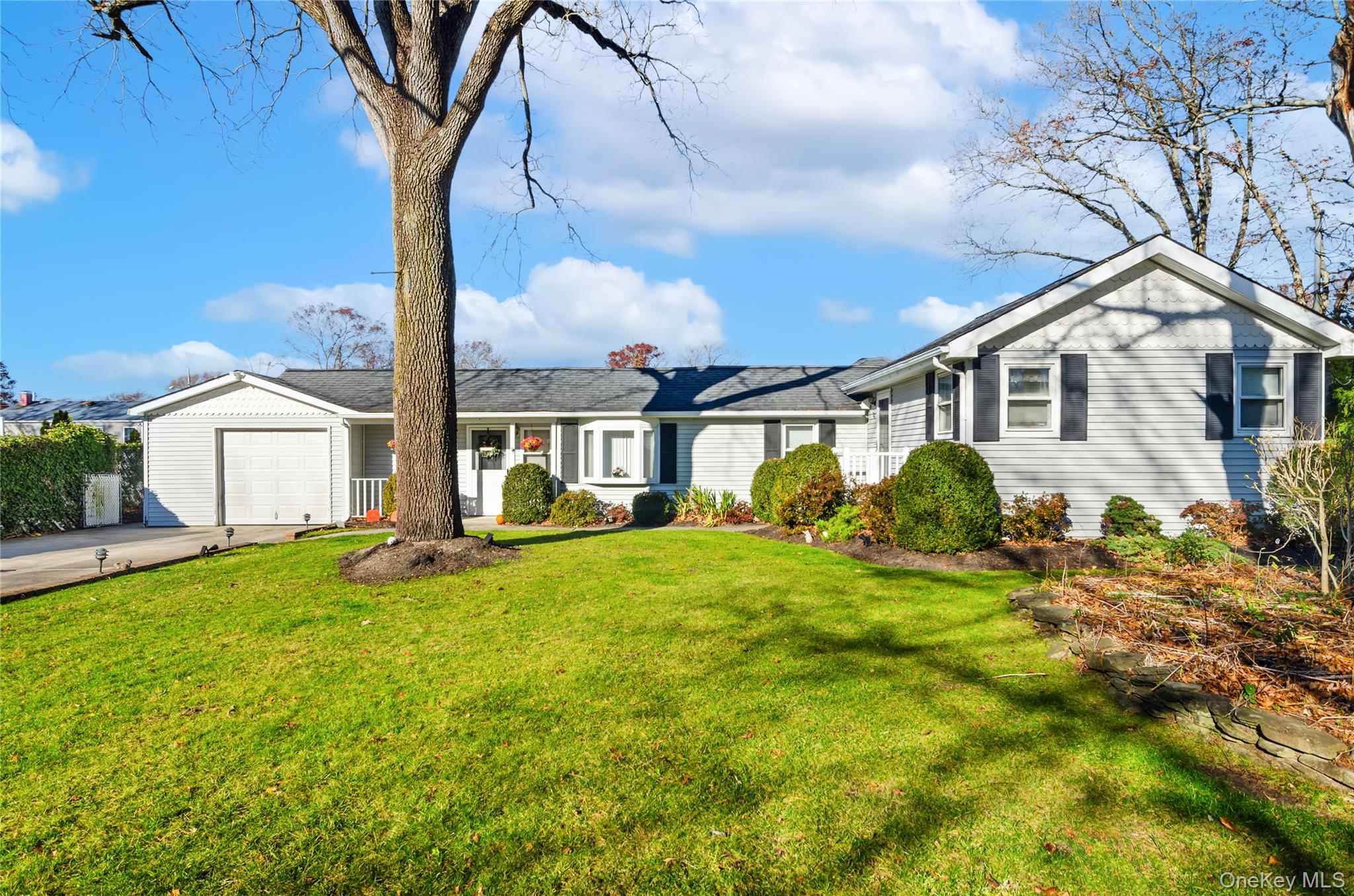 Ranch-style house with a front yard, driveway, and an attached garage