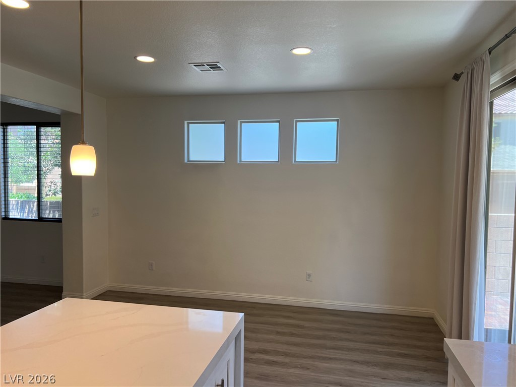 9581 Aberdeen Ridge Court Las Vegas, NV 89148 - Photo 8 of 25 A generous gathering space with rich hardwood floors and recessed lighting, perfect for entertaining.